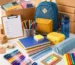 school supplies supplier displaying wholesale stationery supplies, backpack, lunch box, water bottle, notebooks, and pencil case