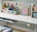 Organized kids study desk with pencil organizer, stationery storage boxes, notebooks, and school supplies.